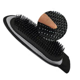 Black and gray hairbrush with a finger rest on a white background