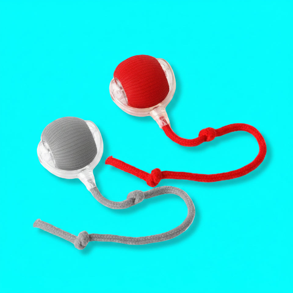 Two dog toys, one red and one gray, with ropes on a white background.