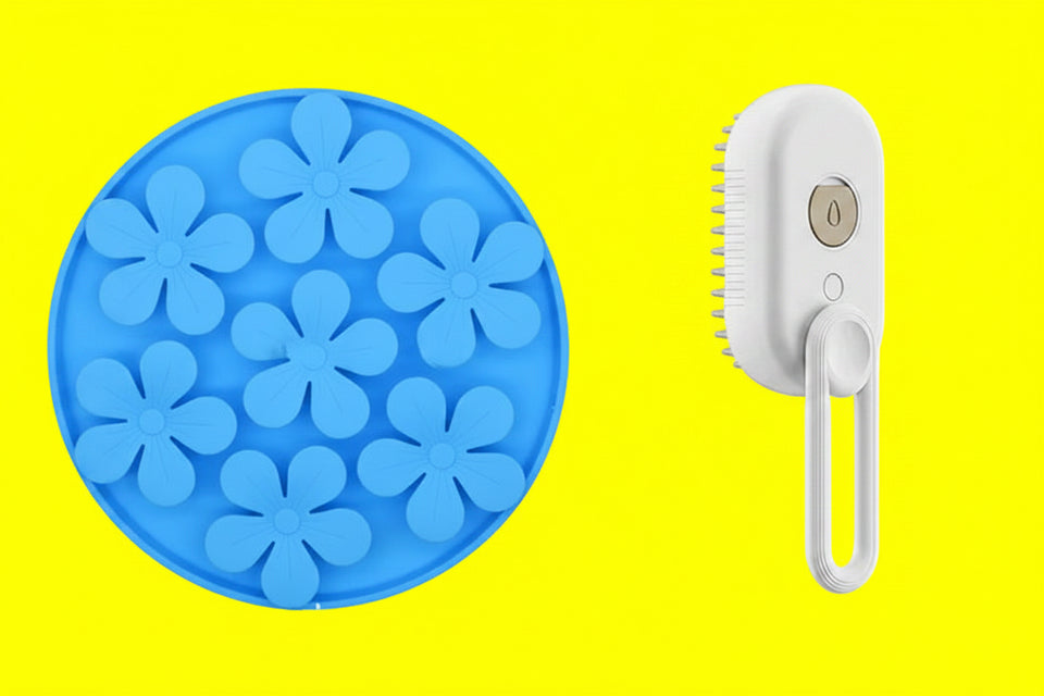 Blue flower-shaped ice cube tray and white handheld brush on a white background
