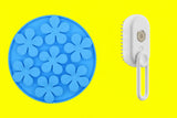 Blue flower-shaped ice cube tray and white handheld brush on a white background