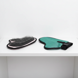 Pink and green grooming gloves on shelf